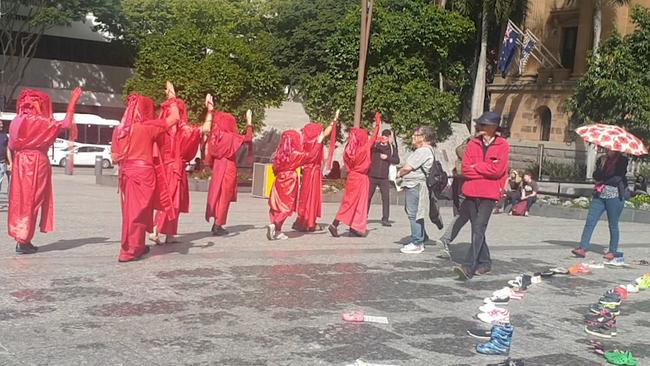 Extinction Rebellion protesters dressed as characters from The Handmaiden's Tale.