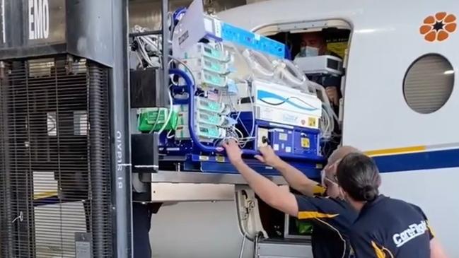 Levi is loaded into the Careflight plane in a travel cot donated by the Humpty Dumpty Foundation. Picture: Supplied