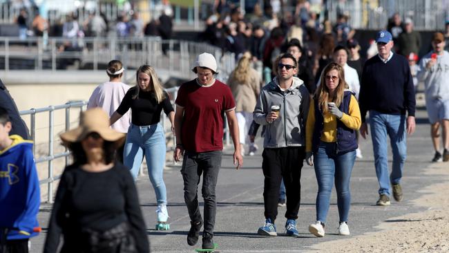 People out and about with no masks at Bondi Beach on Sunday morning. Picture: Damian Shaw