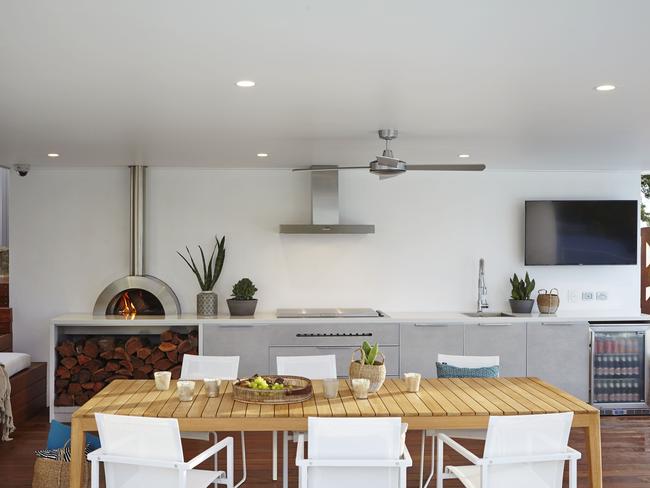 The roof covering in this outdoor kitchen by Rolling Stone Landscapes is essential for using the space all year round.