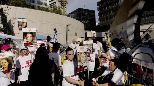 Protesters hold photos of hostages held in the Gaza Strip at a protest encampment calling for the release of all hostages outside the Ministry of Defence in Tel Aviv, Israel. Picture: Amir Levy/Getty Images