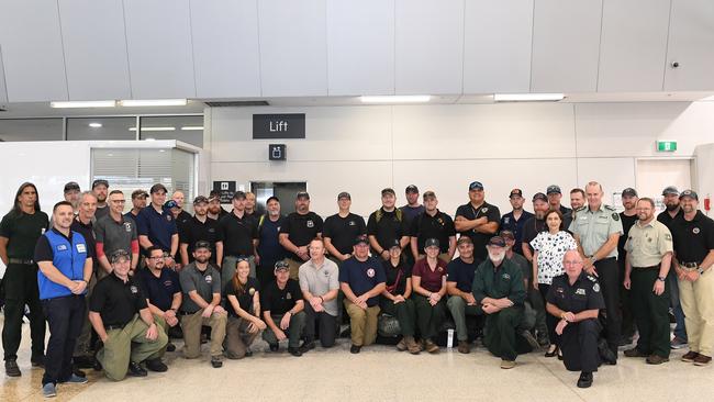 A contingent of 39 firefighters pose for a photo shortly after arriving from North America, at Melbourne Airport in Melbourne. Picture: AAP