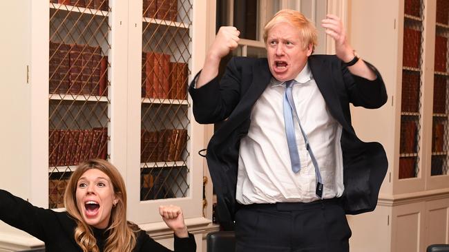 Britain’s Prime Minister Boris Johnson and his partner Carrie Symonds cheers as they watch the 2019 Election results on television at No.10 Downing Street. Picture: Andrew Parsons/i-Images