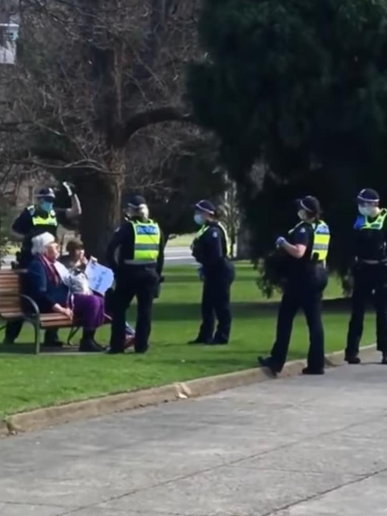 Footage captures police officers surrounding two elderly women as they question them for identification.