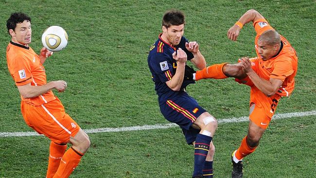 Netherlands' midfielder Nigel de Jong (R) fouls Spain's midfielder Xabi Alonso.