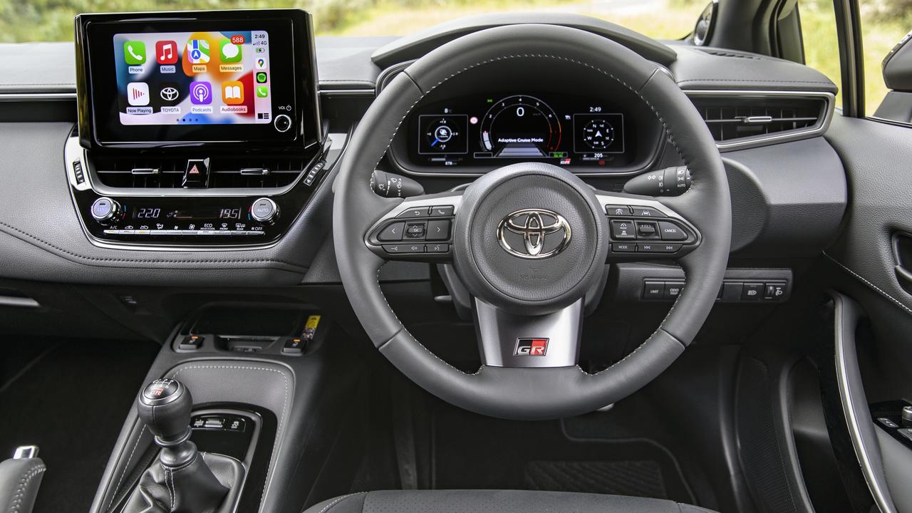 Interior features of the Toyota GR Corolla GTS include bucket front seats and sports pedals, along with digital driver instruments and smartphone mirroring apps.
