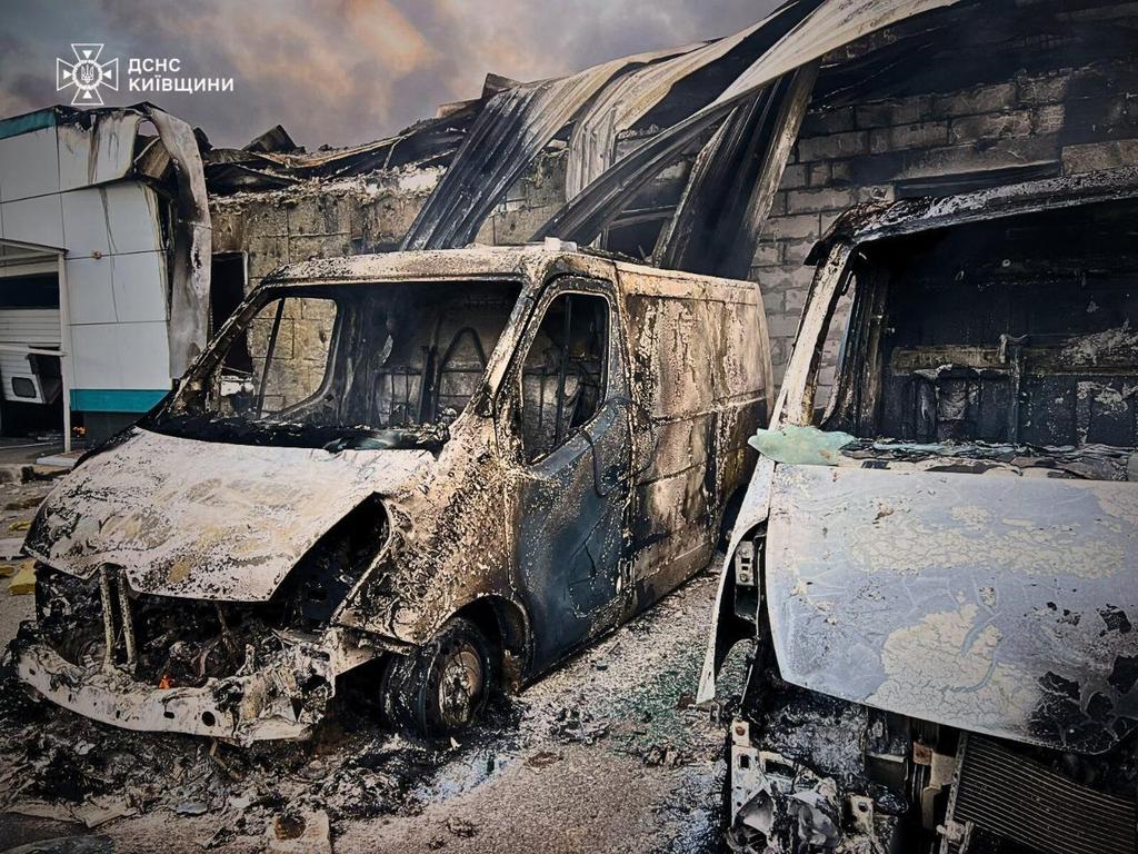 Burned vehicles parked near a civilian building following drone attacks on the Kyiv region. Picture: Handout/Ukrainian State Emergency Service/AFP