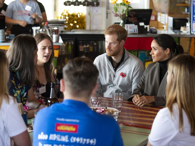 Prince Harry and Meghan chat with representatives of mental health projects at Maranui Cafe in Wellington. Picture: AAP