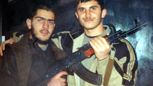 Benbrika terror cell member Aimen Joud (left) holding an AK-47 assault rifle with an unidentified man.