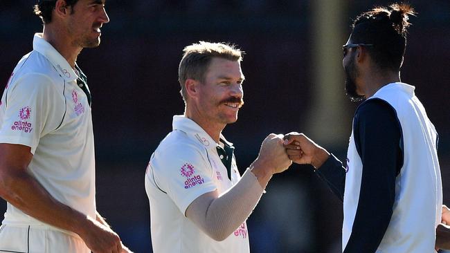 David Warner congratulates Mohammed Siraj on India’s gutsy draw at stumps on day five. Picture: Saeed Khan/AFP