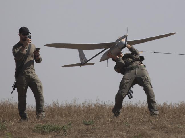 SOUTHERN ISRAEL, ISRAEL - APRIL 15: Israeli soldiers lift a drone near the border with the Gaza Strip on April 15, 2024 in Southern Israel, Israel. Israel's allies, including the UK and US, have urged the country to avoid escalation of conflict with Iran after it launched hundreds of missiles and drones at Israel over the weekend. Meanwhile, foreign mediators in the conflict continue to push for a ceasefire in the war in Gaza and an increase in distribution of humanitarian aid there.(Photo by Amir Levy/Getty Images)