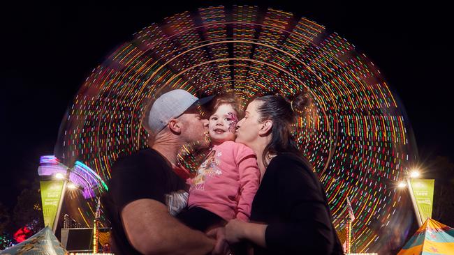 Matt Ritter, Harper, 3 and Tara Cox at the Ferris Wheel. Picture: Matt Loxton