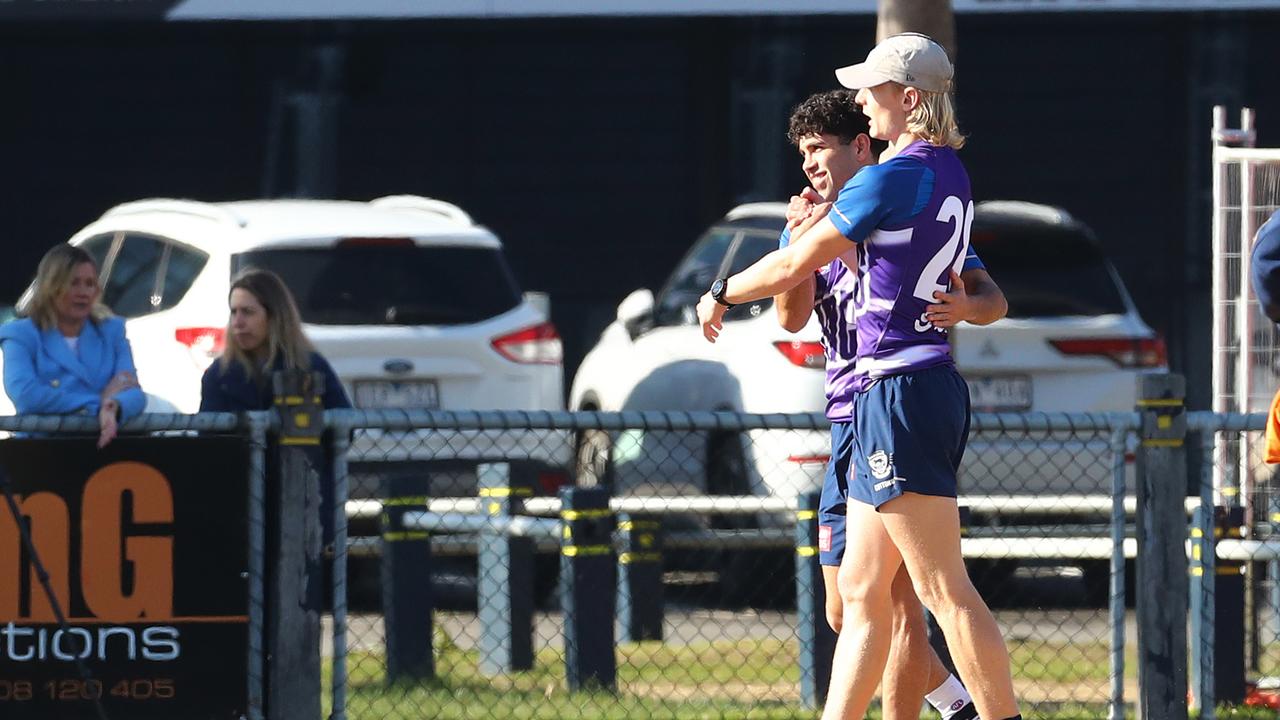 Tyson Stengle back on the training ground gets a hug from Ollie Dempsey. Picture: Alison Wynd