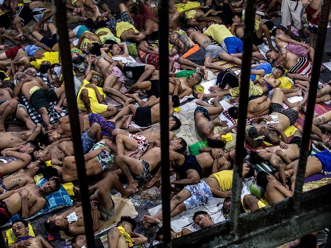 Inmates sleep on an open basketball court inside the Quezon City jail in Manila due to severe congestion. Picture: AFP