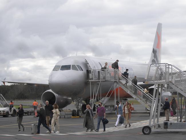 BYRON BAY, AUSTRALIA - JUNE 20: People disembark a domestic Jetstar flight at the Ballina-Byron Gateway Airport on June 20, 2020 in Byron Bay, Australia. Domestic tourists have started to return to Byron Bay following the easing of travel restrictions imposed due to the COVID-19 outbreak. All intrastate travel restrictions were lifted in NSW on June 1, allowing people to travel to regional areas within the state. Although borders between NSW, the ACT and Victoria remain open, Australians have been asked not to holiday interstate. Queensland, Western Australia and Tasmania's state borders remain closed, while South Australia is only open to travellers from WA, Tasmania and the Northern Territory while interstate arrivals to the Northern Territory must self isolate for 14 days. (Photo by Brook Mitchell/Getty Images)