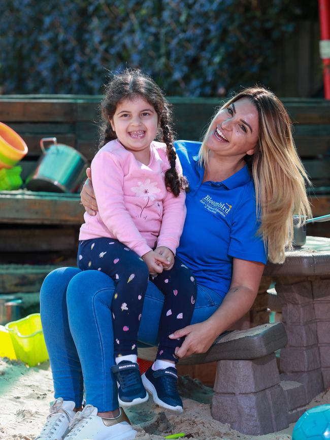 Chrissanthy Tsigolis with Mariella Sahda ,4, at her childcare centre, Bloombirds, in Rosebery. She has decided to cut down prices from $120 to as low as $75 to ensure parents were able to afford keeping their children there. Picture:Justin Lloyd.