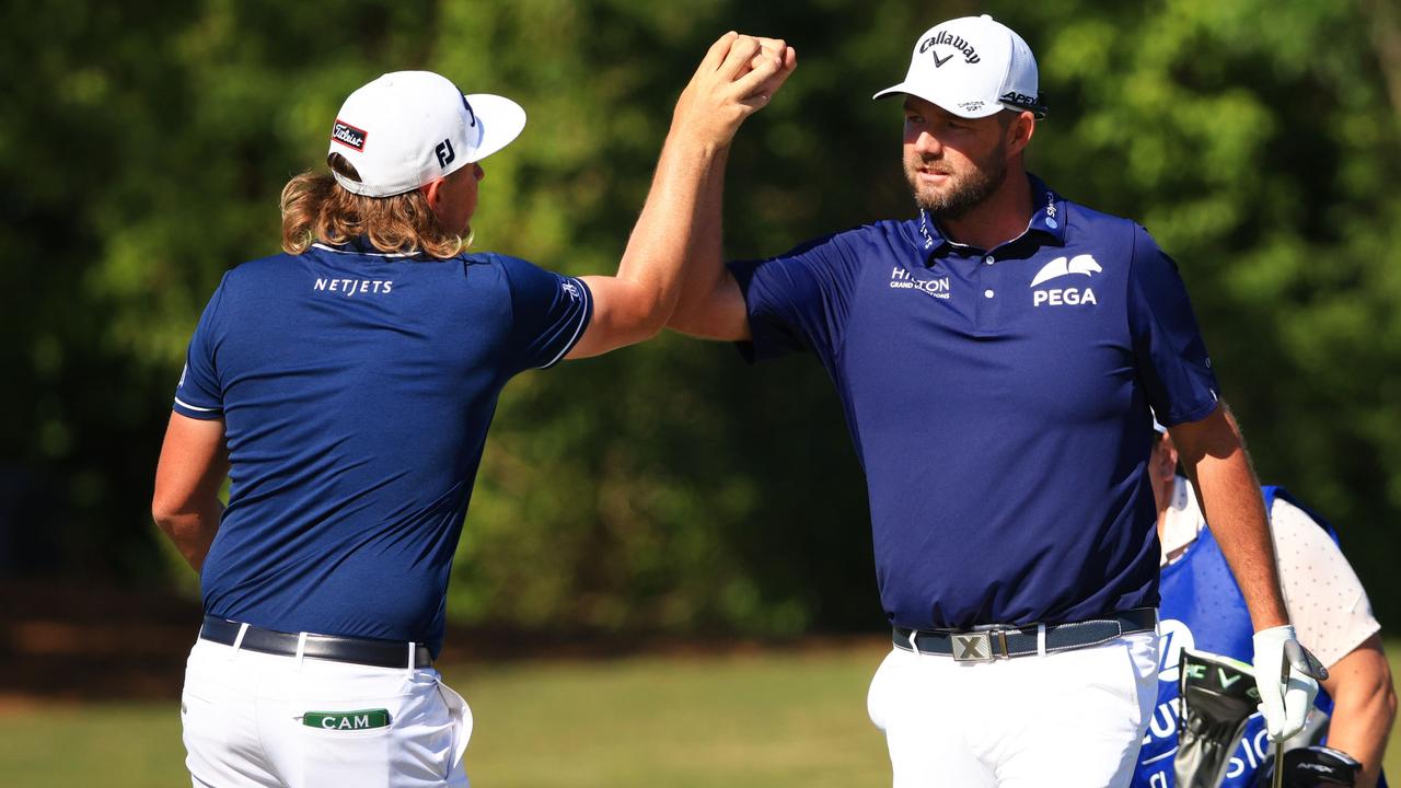 Cameron Smith and Marc Leishman celebrate a birdie in the final round. Picture: Mike Ehrmann/Getty Images/AFP