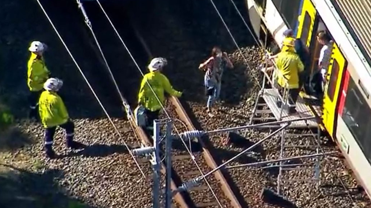 Emergency crews help passengers left stranded on a train between Brisbane and the Gold Coast. Picture: 7News