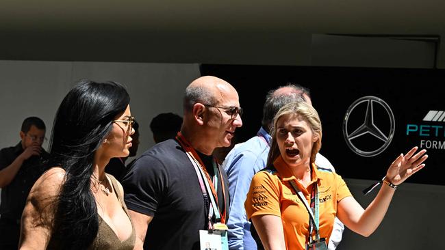 Jeff Bezos with partner Lauren Sanchez (left) in the paddock before the third practice and qualyfying sessions for the 2023 Miami Formula One Grand Prix. (Photo by CHANDAN KHANNA / AFP)