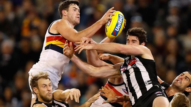 The Odd Couple is not expecting a late finish at Adelaide Oval on Friday night with Mitch McGovern rising above the rain clouds to pull down a mark to save the game for the Crows. Picture: Michael Willson (Getty Images)