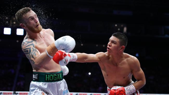 Jaime Munguia (L) lands a right hand on Dennis Hogan. Picture: Getty