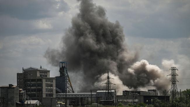 Smoke and dirt ascends after a strike at a factory in Soledar. Picture: AFP.