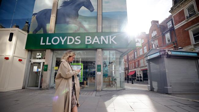 A pedestrian walks past a temporarily closed-down branch of a Lloyds Bank in London. Picture: AFP