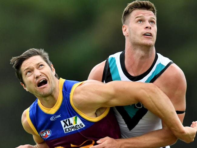 Stefan Martin (left) of the Lions grapples with Peter Ladhams (right) of the Power in the ruck during the AFL Marsh Community Series pre-season match between the Brisbane Lions and the Port Adelaide Power at the Moreton Bay Central Sports Complex in Burpengary, Queensland, Sunday, February 23, 2020. (AAP Image/Darren England) NO ARCHIVING, EDITORIAL USE ONLY