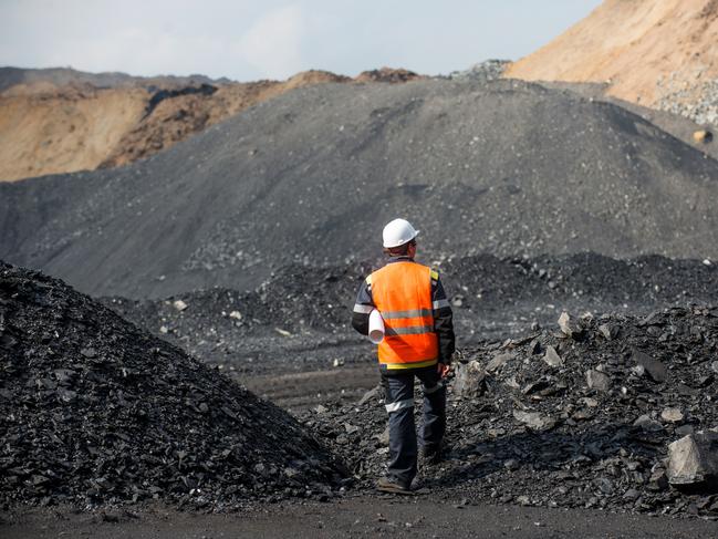 Coal mining in an open pit - Worker is looking on the huge open pit