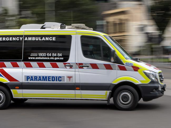 MELBOURNE, AUSTRALIA - NewsWire Photos FEBRUARY 13, 2022: An ambulance speeds away from the Royal Melbourne Hospital. Ambulance, Generic.Picture: NCA NewsWire / David Geraghty