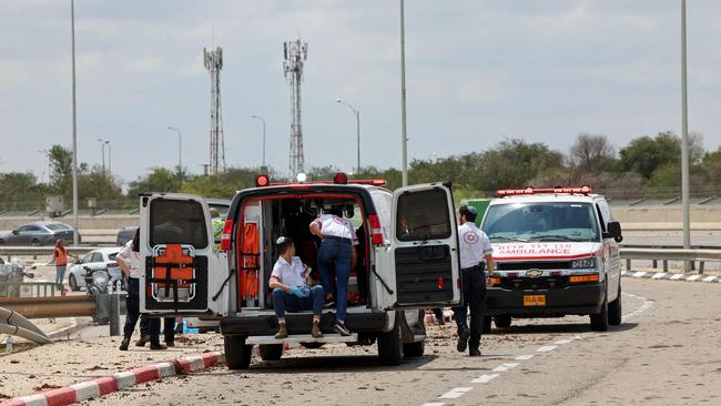 Israeli medical emergency services stand by on a mud-splattered road outside Israel's Ben Gurion airport. Picture: AFP