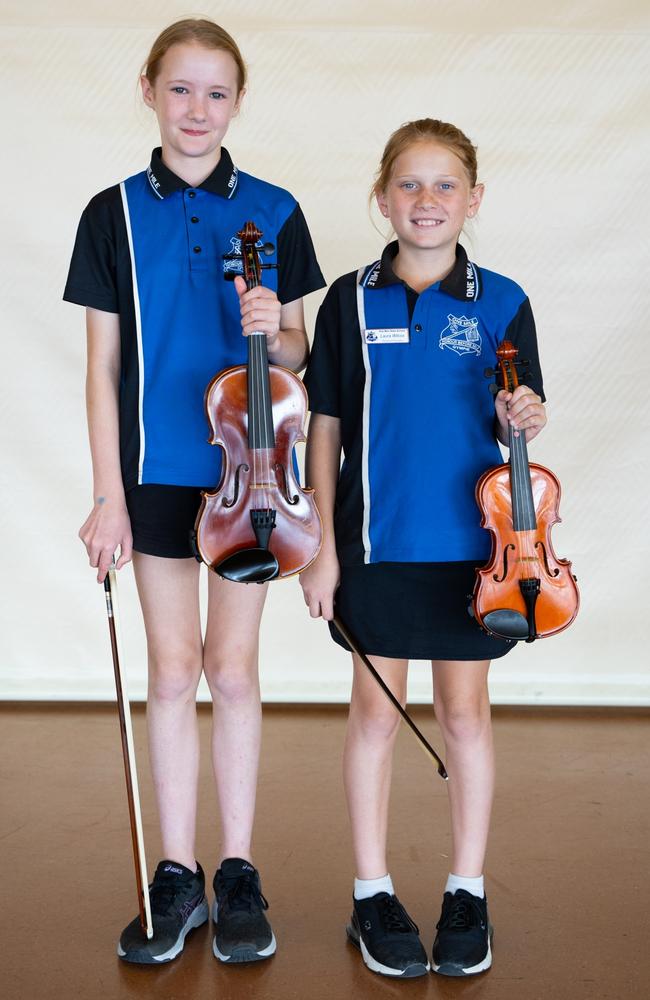 Maya McBride and Laura Wilcox from One Mile State School prepare for the small instrumental ensemble strings (primary school) at the Gympie Eisteddfod. August 1, 2023. Picture: Christine Schindler