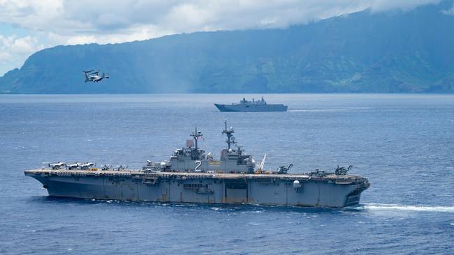 The Wasp-class amphibious assault ship USS Essex, front, and the Royal Australian Navy Canberra-class landing helicopter dock HMAS Canberra transit the Pacific Ocean during Rim of the Pacific 2022. Picture: US Navy