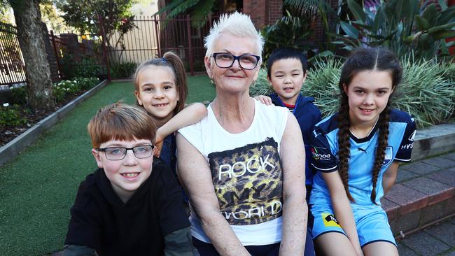 Anne Rees, principal of St Mary’s Catholic Primary in Sydney’s Erskineville, with students Ryan Mulrey, Kiki Kersten, Lucas Shi and Audrey Binning. The school has a similar SES score to the exclusive King’s School under the current system. Picture:   John Feder