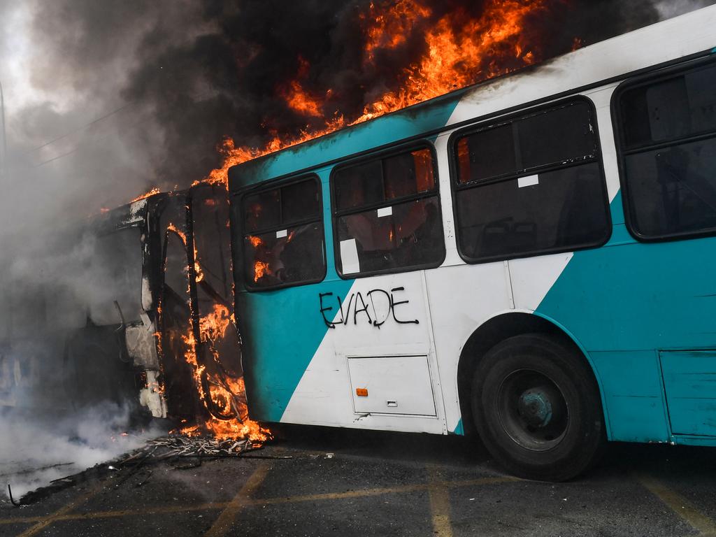 A bus burns down during clashes between protesters and the riot police in Santiago. Picture: AFP