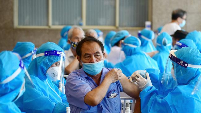 A man receives the AstraZeneca Covid-19 vaccine in Hanoi. About 2.3 billion of the world’s 7.8 billion people have been fully vaccinated. Picture: AFP