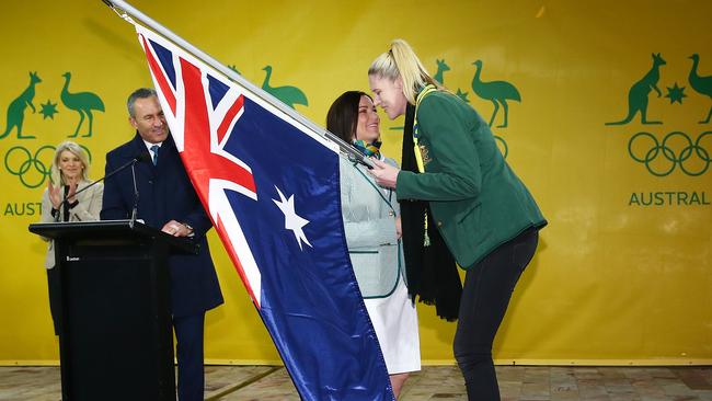 Anna Meares is presented with the Australian flag by Lauren Jackson, flag-bearer for the 2012 London Olympic Games. Picture: Getty Images