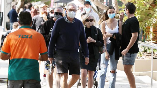 Holiday-makers mask up on Hastings Street in Noosa as parts of Queensland prepare to enter a snap three-day lockdown. Picture: Lachie Millard