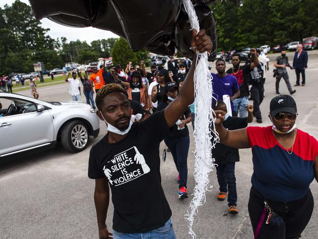 Members of Hoke County Peacekeepers bring balloons to release in honour of George Floyd. Picture: AFP