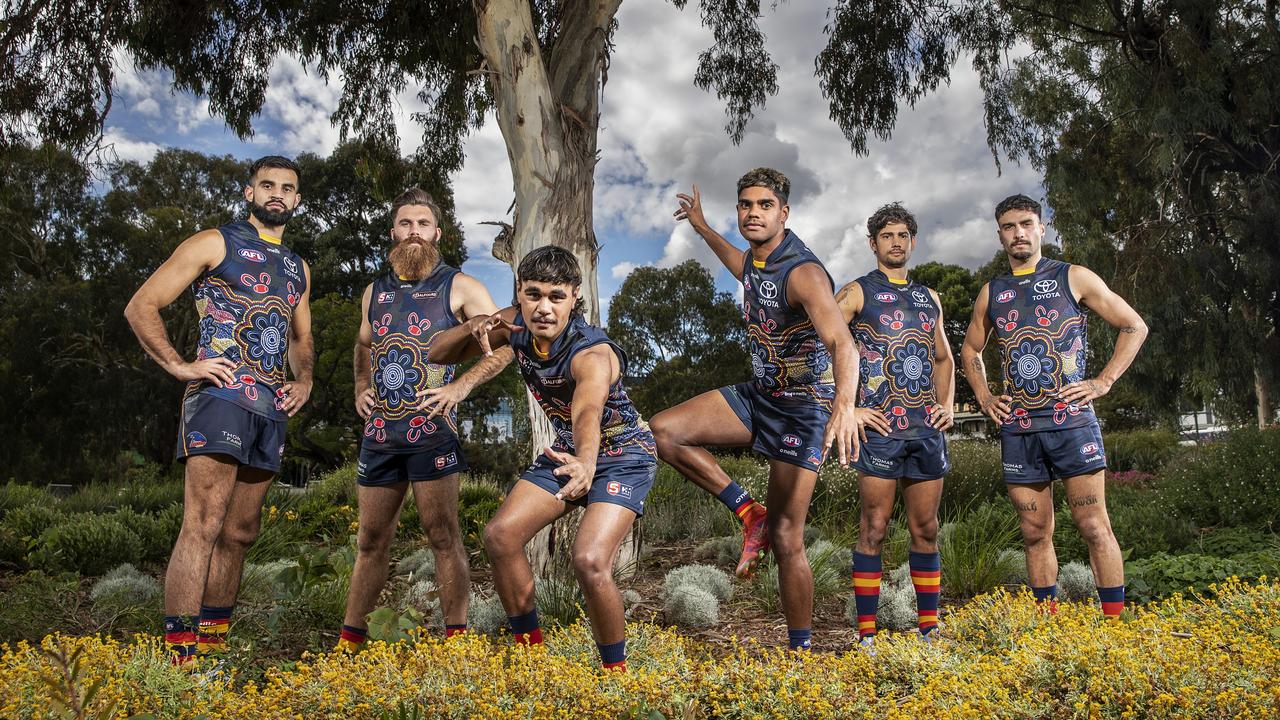 Crows players Wayne Milera, Isaya McKenzie, Tariek Newchurch, Blayne O'Loughlin, Shane McAdam and Izak Rankine pose in the jumper designed by Danielle Ponter's Aunty April Napangardi Campbell Picture: Getty Images