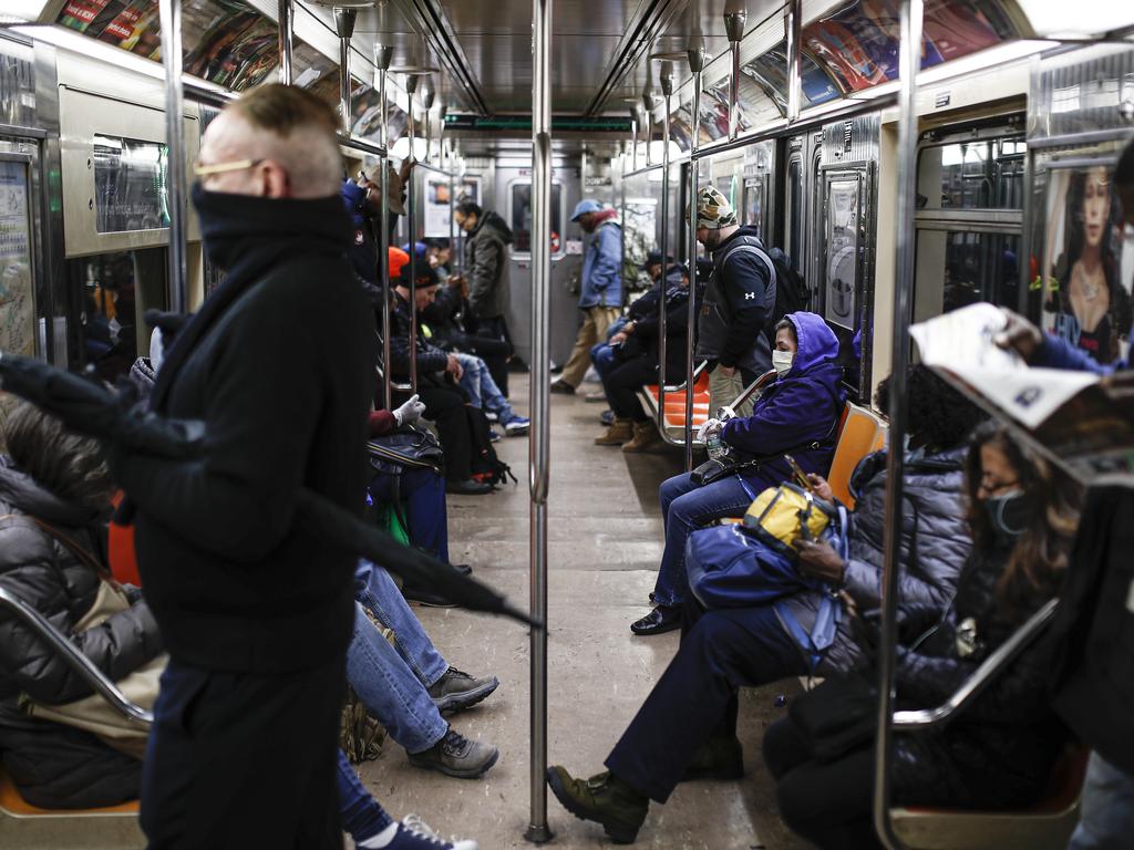 People ride the Subway in New York before it was shut down for a nightly disinfection. Picture: AP Photo/John Minchillo.