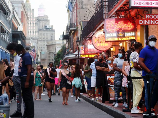 NEW ORLEANS, LOUISIANA - AUGUST 13: People (R) wait in line to enter a restaurant in the French Quarter on August 13, 2021 in New Orleans, Louisiana. Louisiana holds one of the nationâs lowest vaccination rates with just 38 percent of its residents fully-vaccinated. As of August 12, the state had the highest amount of COVID cases per capita in the U.S. over the previous 14 days.   Mario Tama/Getty Images/AFP == FOR NEWSPAPERS, INTERNET, TELCOS & TELEVISION USE ONLY ==