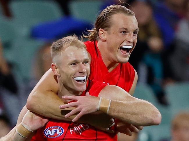 ADELAIDE, AUSTRALIA - APRIL 15: Nick Hind of the Bombers celebrates a goal with teammate Mason Redman during the 2023 AFL Round 05 match between the Essendon Bombers and the Melbourne Demons at Adelaide Oval on April 15, 2023 in Adelaide, Australia. (Photo by Dylan Burns/AFL Photos via Getty Images)