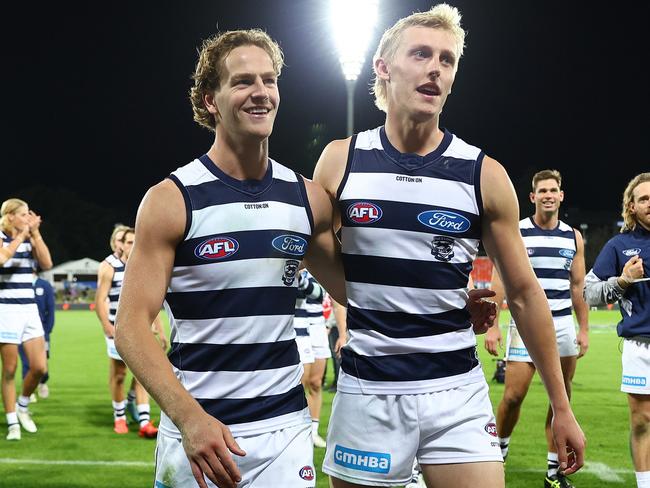 Cooper Stephens and Mitch Knevitt are clapped from the field after their debut. Picture: Mark Metcalfe/AFL Photos/via Getty Images