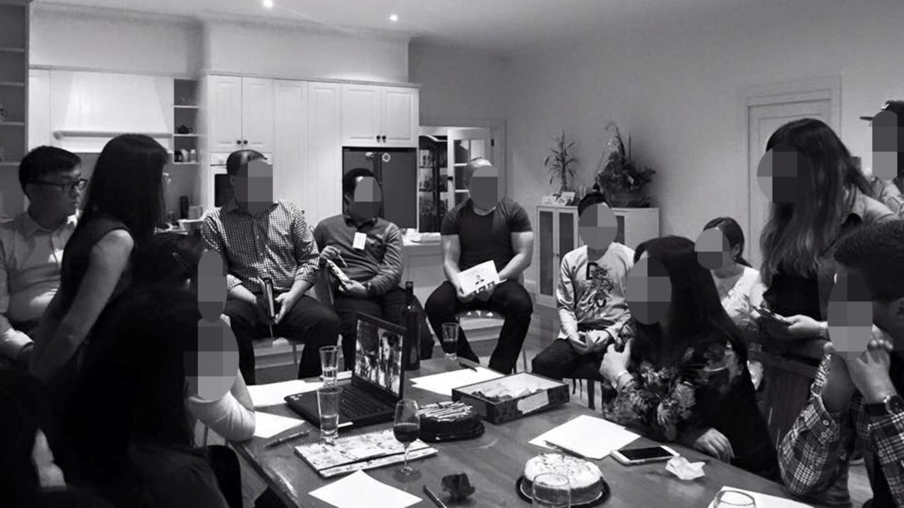 Liberal MP Gladys Liu standing next to Nick Zhao, far left, wearing glasses, in her house in 2016.