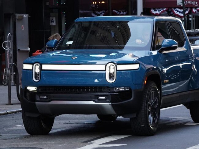 A Rivian R1T electric pickup truck during the company's IPO outside the Nasdaq MarketSite in New York, U.S., on Wednesday, Nov. 10, 2021. Electric vehicle-maker Rivian Automotive Inc. priced shares in its initial public offering at $78 apiece to raise about $11.9 billion, the biggest first-time share sale this year. Photographer: Bing Guan/Bloomberg