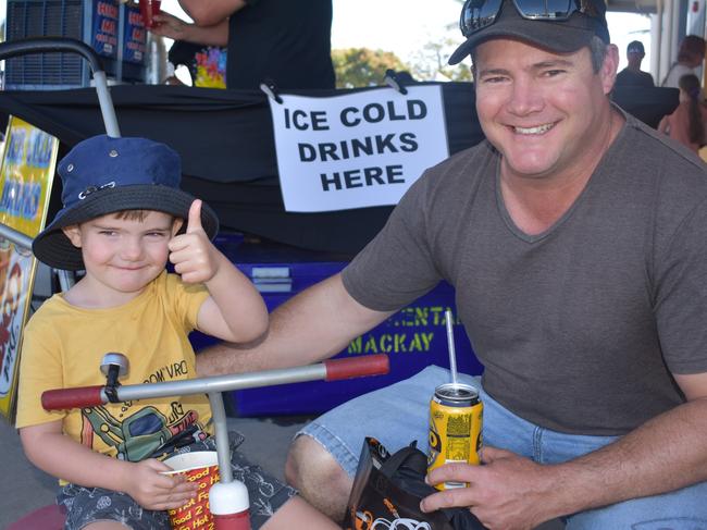 Byron, 3, and Daniel Wade at Big Boys Toys Expo at Mackay Showgrounds 2021. The pair drove in from Moranbah for the expo and Bryon has loved the sideshow alley. Photo: Janessa Ekert and Tara Miko