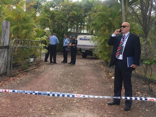 Police outside the Hervey Bay home, where a mother, father and their daughter were all shot.
