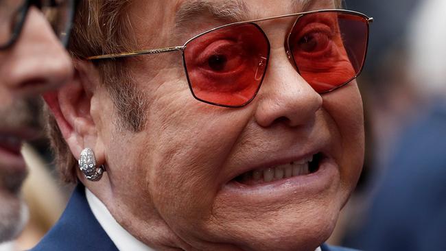 English singer-songwriter Elton John (R) and his husband Canadian producer David Furnish pose on the red carpet upon arriving for the UK premiere of the film Rocketman in London on May 20, 2019. (Photo by Adrian DENNIS / AFP)