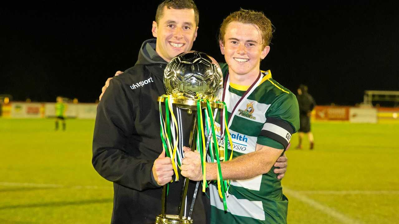 Western Pride coach Graham Harvey and captain Jesse Rigby collect the NPL Queensland grand final trophy. Picture: Chris Simpson